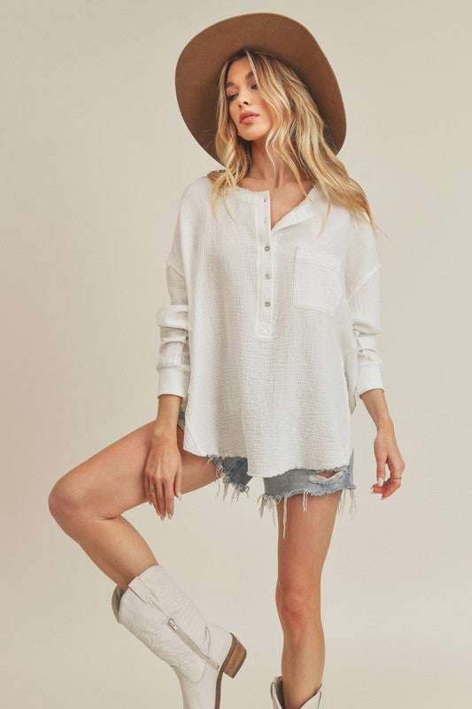 Stylish Long Sleeve Top with Unique Hem and Button Detail